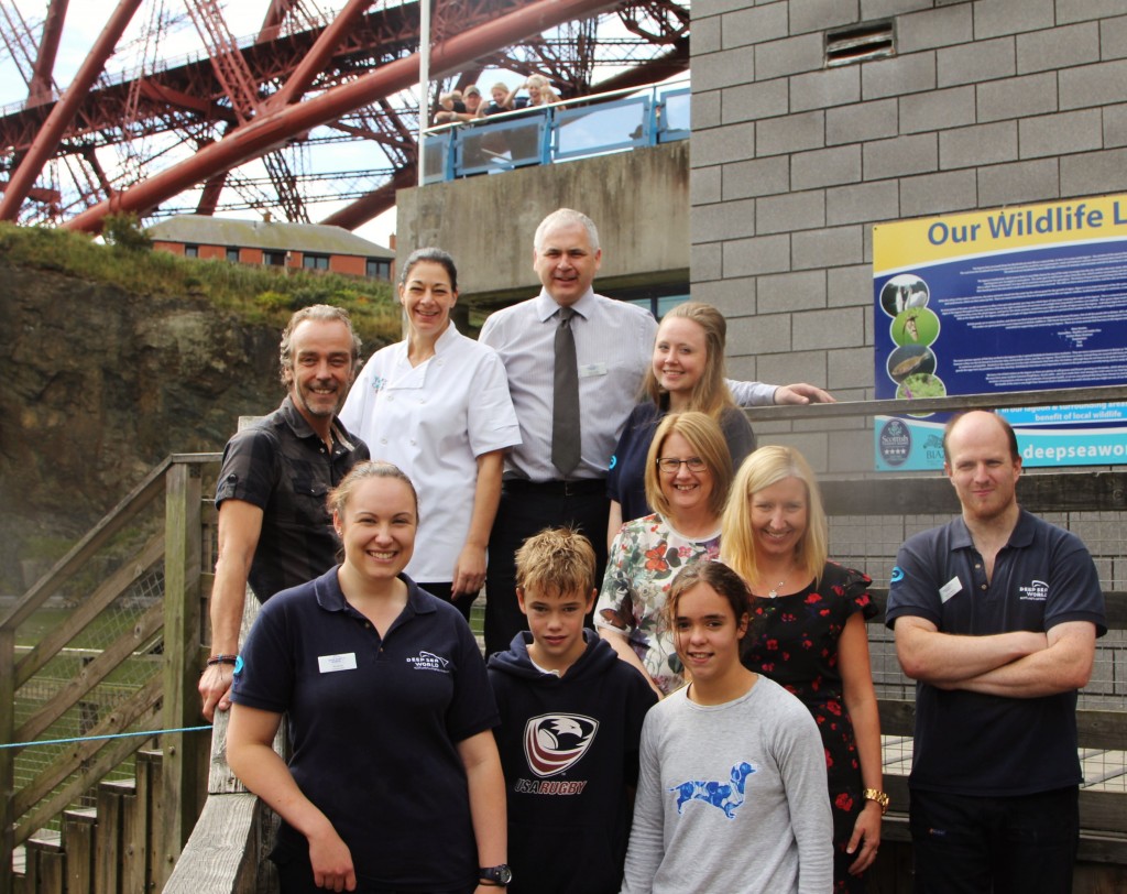 John Hannah, left, with his kids and members of the Deep Sea World team
