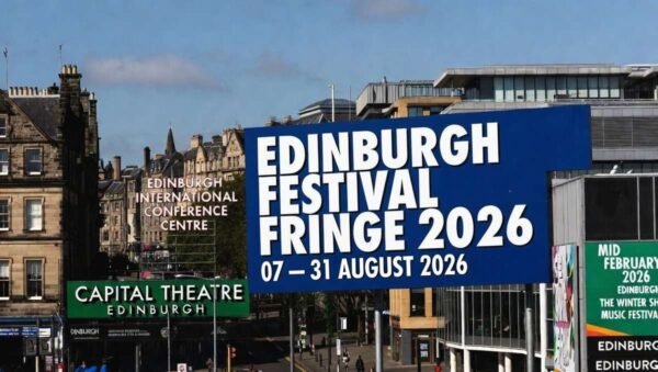 Edinburgh Fringe 2026 billboard announcement in city centre with blue sky and historic buildings