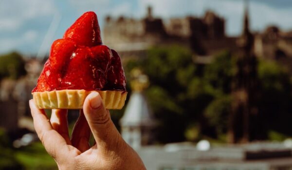 Fresh strawberry tart from Eusebi Bakery at Bonnie & Wild, St James Quarter, with Edinburgh Castle in the background