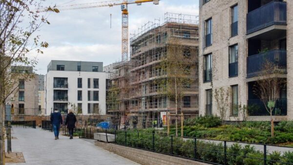 Modern housing blocks and construction work representing Edinburgh housing investment