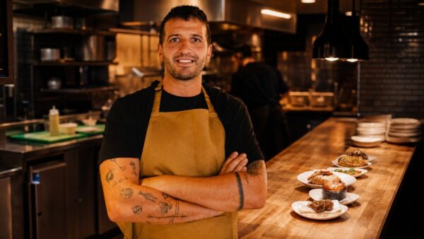 Chef Nico Simeone-style figure inside a warm restaurant kitchen for the Lennox Edinburgh opening