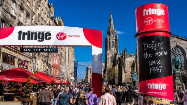 Edinburgh Festival Fringe crowds and signage on the Royal Mile