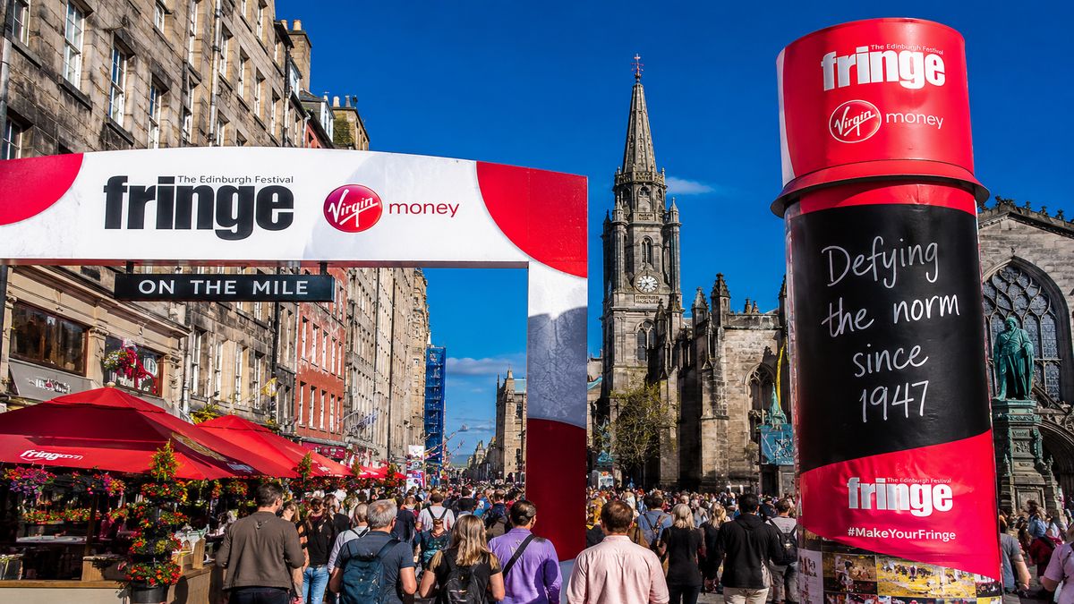 Edinburgh Festival Fringe crowds and signage on the Royal Mile